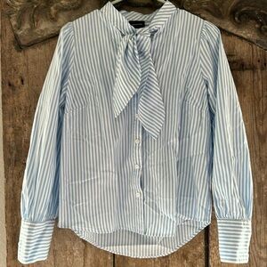 Who What Wear white and blue striped blouse with tie around neck.